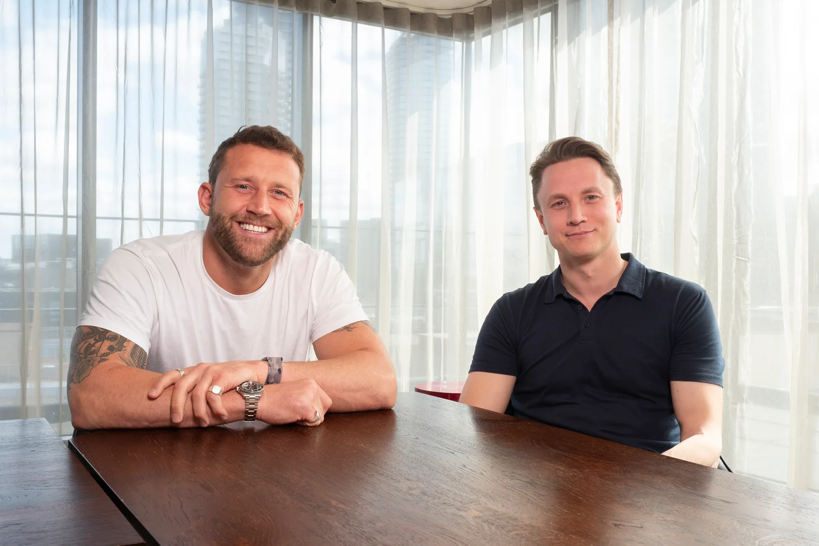 Detected co-founders Liam Chennells, left, and Peter Youell, right, seated together at a table.